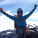 Carol Masheter on the summit of Carstensz Pyramid